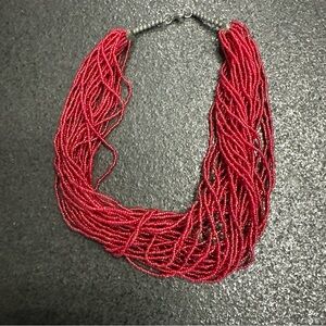 Vintage red multi-strand seed bead necklace with a silver-tone hook clasp.